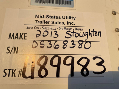 Label on trailer showing MAKE 2013 Stoughton, S/N D536830, STK # U89983, MId-State Utility Trailer Sales sticker with handwritten info.
