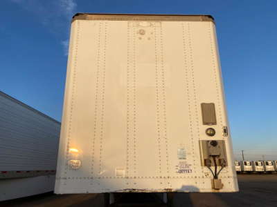 Rear view of a white 2013 Stoughton van trailer with doors closed showing riveted panels, and a rear access door with locking latch and reflectors.