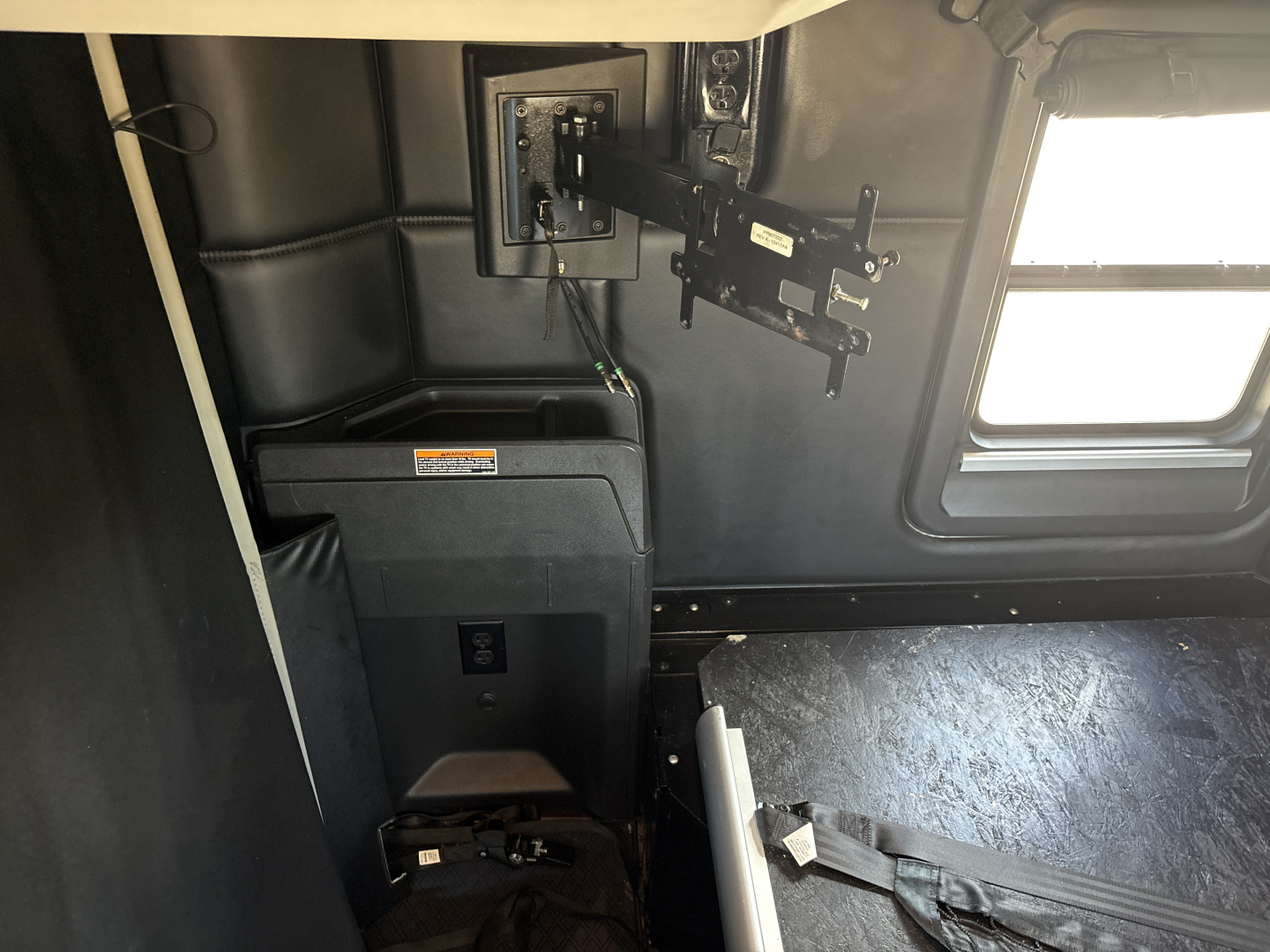 Kenworth T680 cab interior showing mounting bracket and control panel area with window in view.