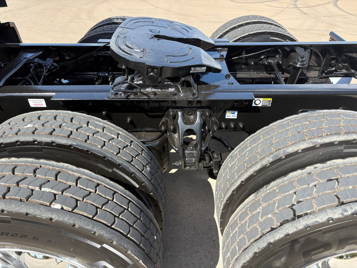 Kenworth T680 chassis with fifth wheel and dual rear axles, showing heavy-duty dual tires and frame rails.