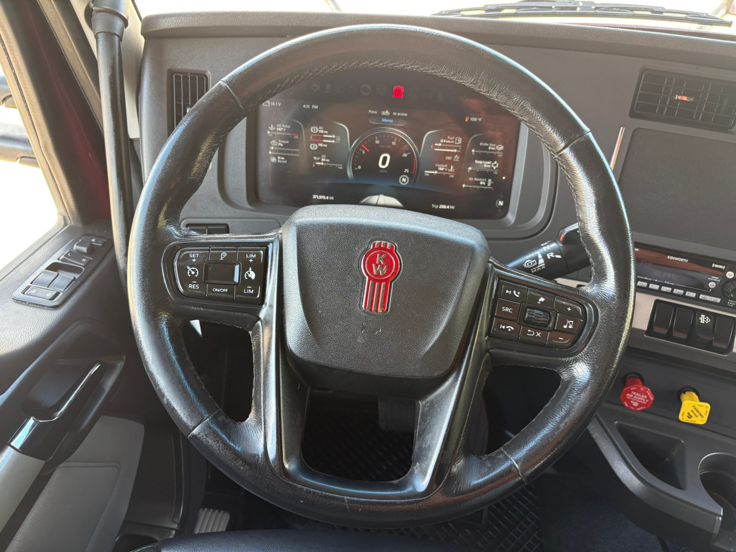 Kenworth T680 steering wheel and dashboard with digital gauge cluster.