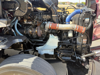 Kenworth T680 engine bay showing intake piping, hoses, and components in view.