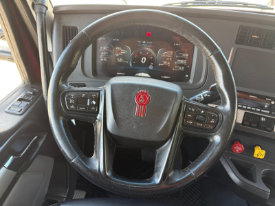 Kenworth T680 steering wheel and dashboard with digital gauge cluster.