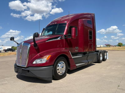 Kenworth T680 sleeper cab truck in maroon showing front and side view with chrome grille and dual rear axles.