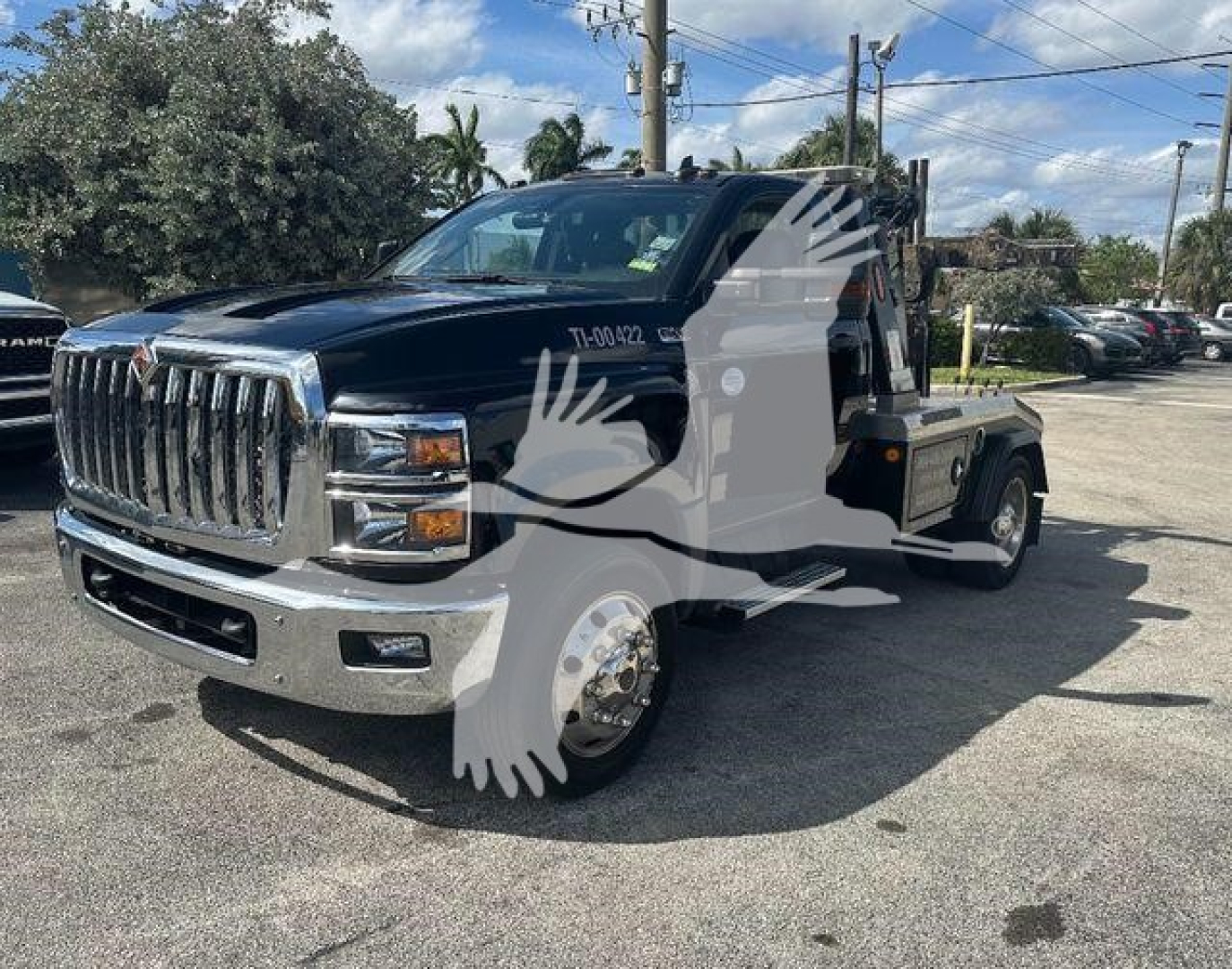 2019 International CV truck with winch, front grille chrome, dark blue cab, flatbed, used condition.