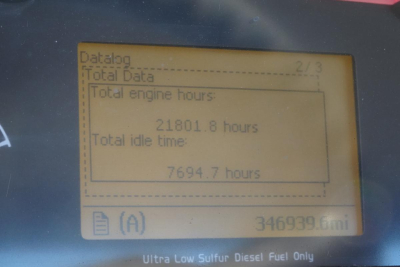 Truck instrument display showing data: Total engine hours 21801.8 hours, Total idle time 7694.7 hours, odometer 346939.6 miles. Ultra Low Sulfur Diesel Fuel Only label at bottom.