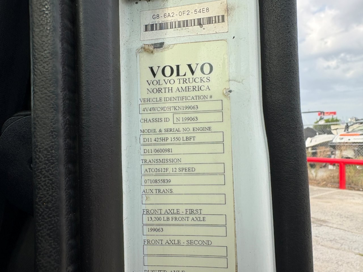 Volvo truck data plate showing VIN, engine, transmission, axles, and specs inside door jamb.