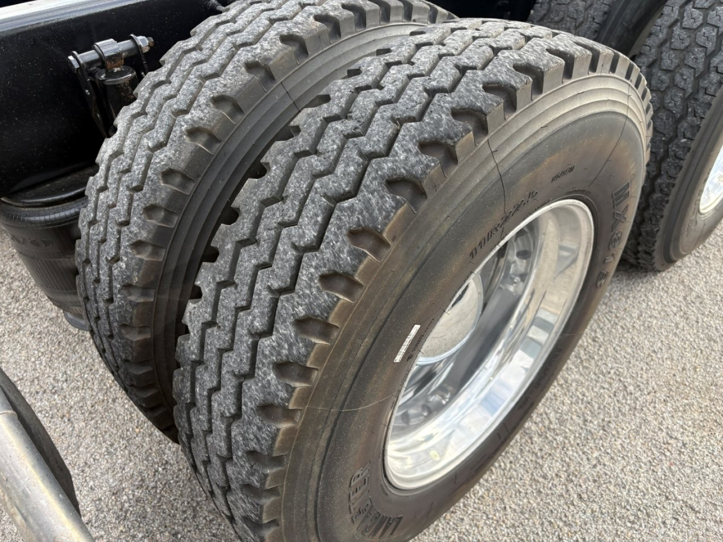 Dual rear tires on Volvo VNR64T640 truck showing tread pattern and chrome wheel well.