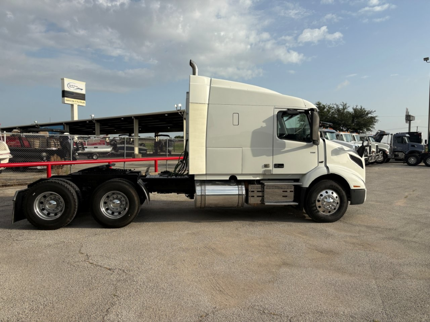 Volvo VNR64T640 conventional sleeper truck side view showing cab, long wheelbase, and flatbed trailer hitch