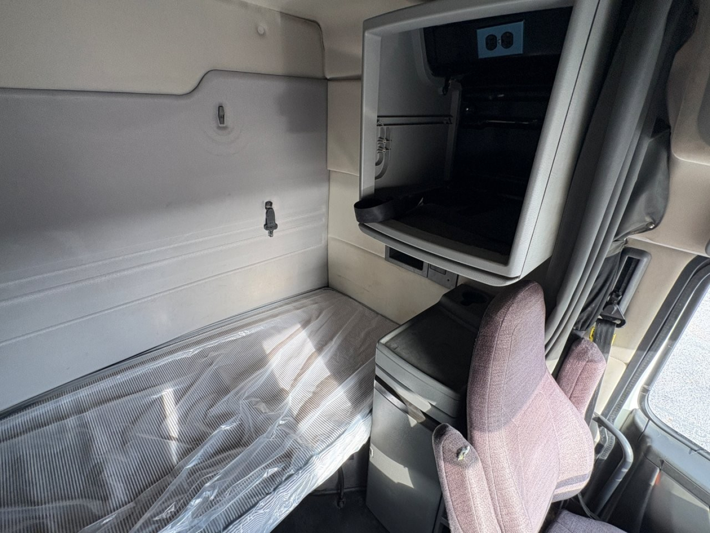 Volvo truck cab interior sleeper area showing bunk space and storage cabinet
