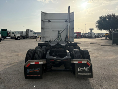 Rear view of a Volvo VNR truck tractor chassis with fifth wheel removed; dual rear axles, mud flaps showing Buckner's Truck logos