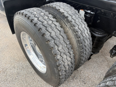 Dual rear truck tires showing tread on a Volvo VNR64T640 chassis with suspension components.