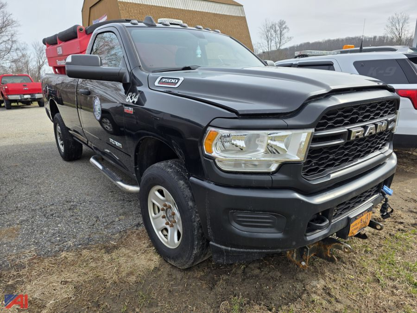 Ram 3500 pickup truck with plow showing front grille and headlights.
