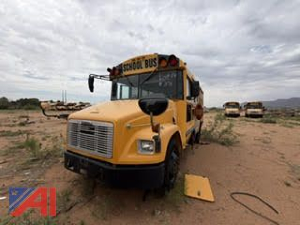School bus front view with yellow Freightliner FS65, 2005 model, in a desert area.