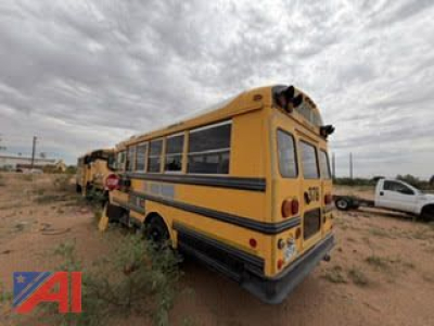 2005 Freightliner FS65 school bus rear-left view showing yellow body, black trim, roof air system, and rear bumper.