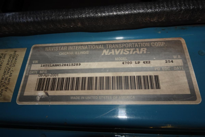 Vehicle ID plate showing NAVISTAR INTERNATIONAL TRANSPORTATION CORP. Navistar model 4700 LP 4X2, VIN 1HTSLABM12H415289, date 09-Apr-2001, made in United States of America.