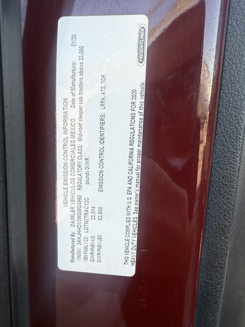 Label on Freightliner Cascadia showing vehicle control information and standards; sticker includes manufacturer details, VIN, and regulatory info.