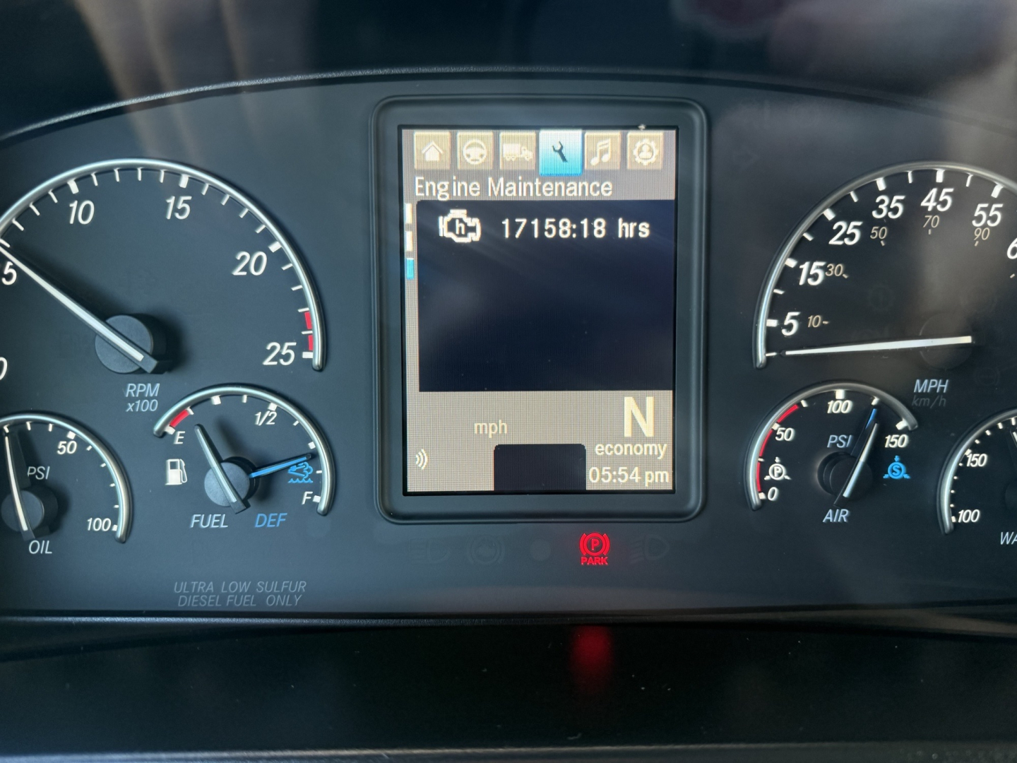 Dashboard panel of a 2021 Freightliner Cascadia126 showing engine maintenance message and gear selector in N with economy mode.