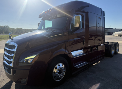 Freightliner Cascadia 126 Class 8 sleeper tractor in view showing front grille and side fuel tanks.