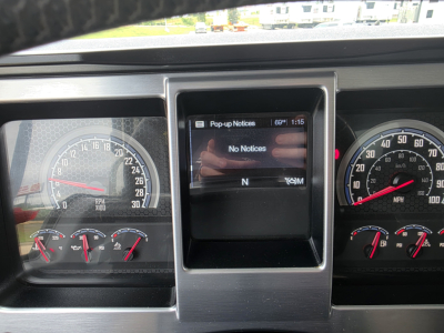 Dashboard view of a 2021 Mack Granite truck showing gauges and a central display with 'Pop-up Notices' screen, no notices visible, instrument cluster includes speedometer and tachometer.