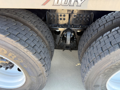Kenworth T880 rear drivetrain showing dual rear axles and fifth-wheel mounting area with heavy-duty suspension components.