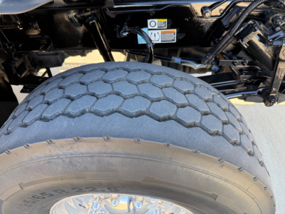 Kenworth T880 mixer truck rear view showing dual rear wheels and tire tread.