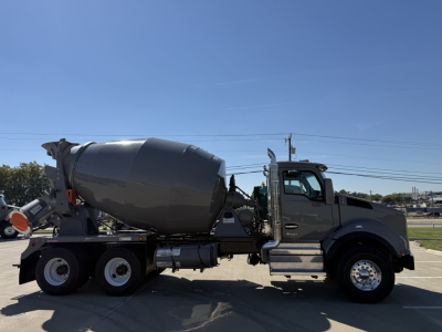 Kenworth T880 mixer truck in side view with concrete mixer drum and cab, showing front wheel and dual rear axles.