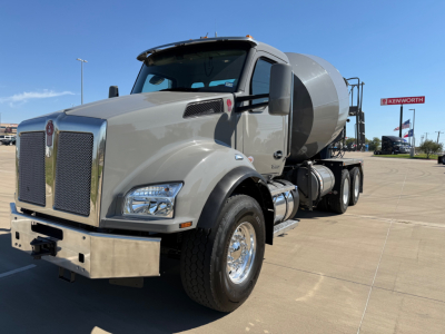 Kenworth T880 concrete mixer truck in service showing front grille, cab, and mixer drum.