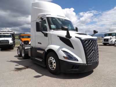 Volvo VNL64T300 tractor cab in white, front three-quarter view, with tall sleeper, glossy grille, and side mirrors visible.