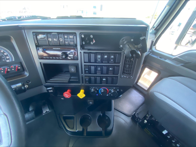 Dashboard interior of a 2019 Mack AN64T70 truck showing gear selector area, switch panels, ignition, and auxiliary controls.