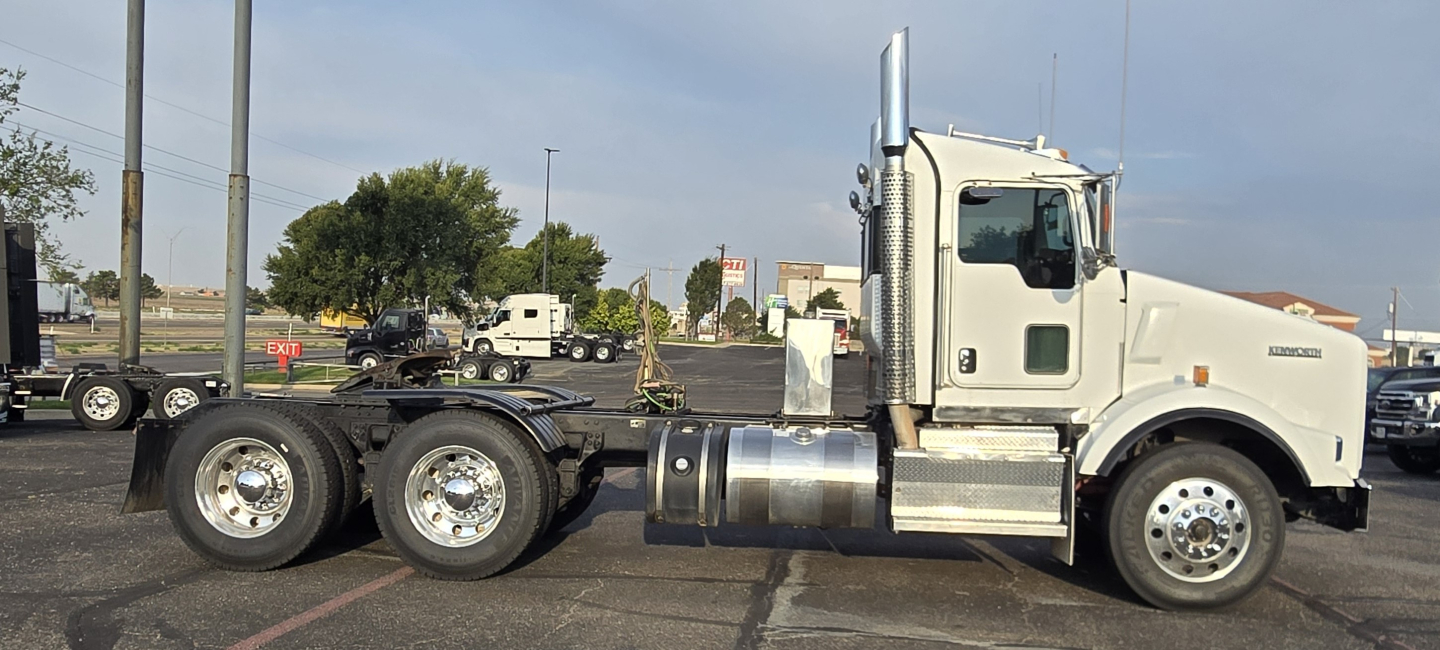 Kenworth T800 conventional daycab tractor showing chassis and cab with dual rear axles and fuel tanks. No text legible on labels visible.
