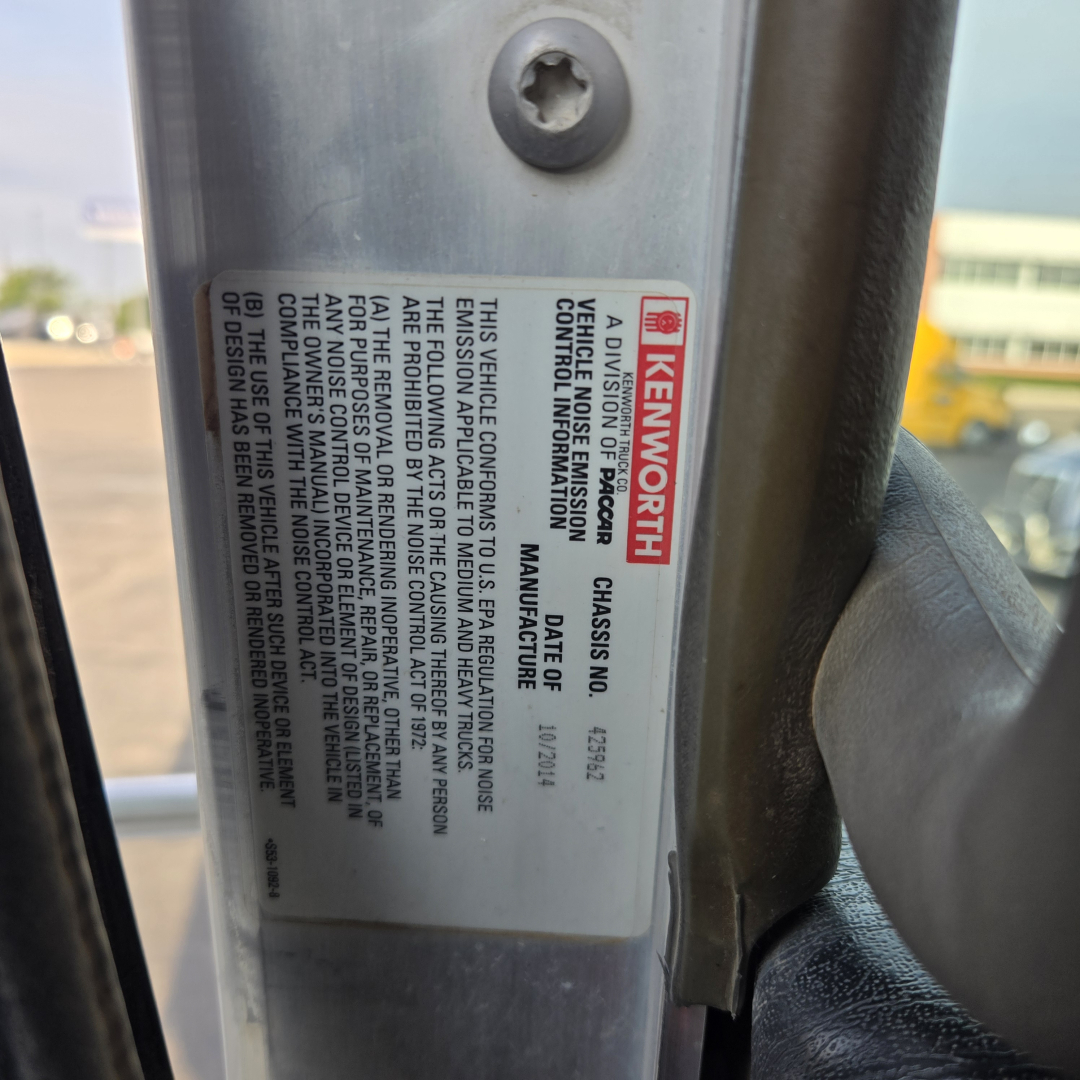 Kenworth truck door sticker with model and VIN information visible on the frame. The label includes 'KENWORTH', and vehicle identification details.