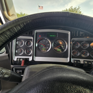 Kenworth T800 dashboard view showing gauge cluster and steering wheel with digital readout