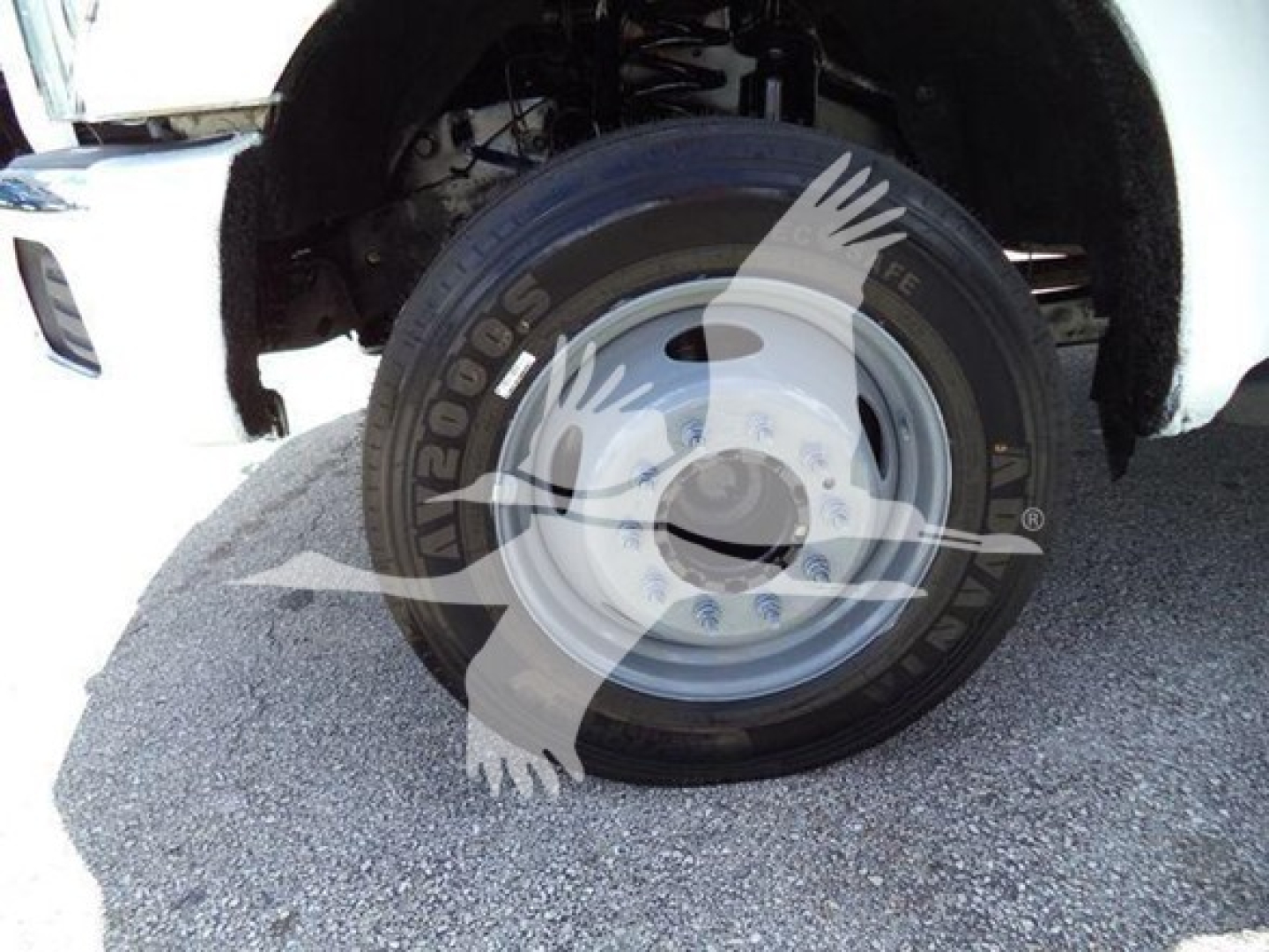 Ford F-550 front wheel and tire assembly with steel rim, visible suspension components.