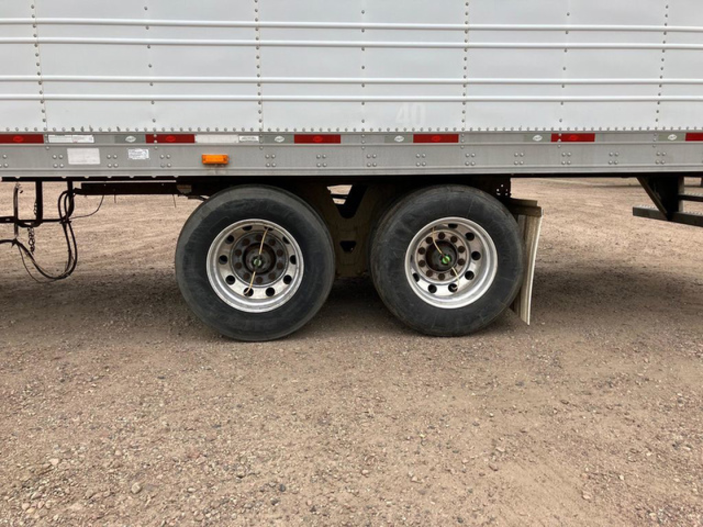 Trailer dual rear wheels of a 2012 utility reefer showing aluminum sidewall and tires.