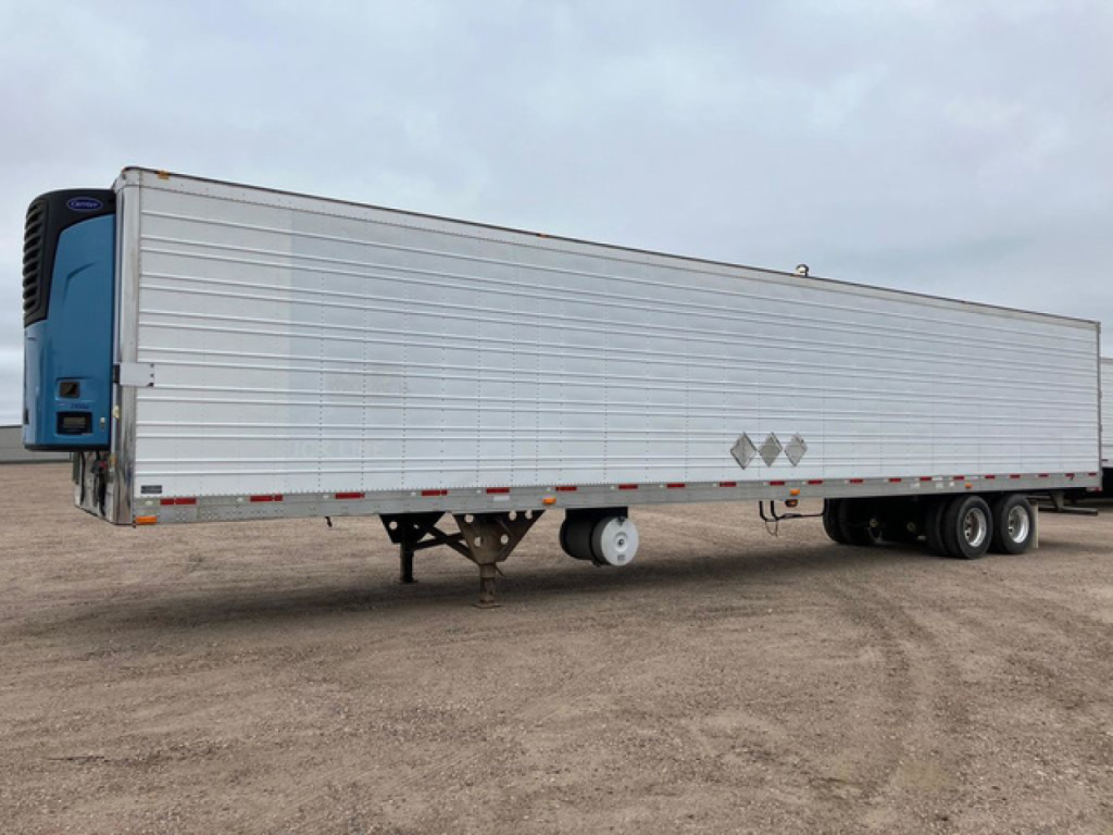 Trailer side view showing a 2012 utility reefer refrigerated trailer with silver siderails and blue nose, stock number U91184, VIN 1UYVS2530CU294304.