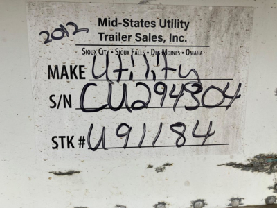 Trailer tag showing Make UT? Utility with handwritten VIN and stock number. Text includes Mid-States Utility Trailer Sales, Inc. with locations Sioux City, Sioux Falls, Des Moines, Omaha; S/N C U294304; STK# U91184.