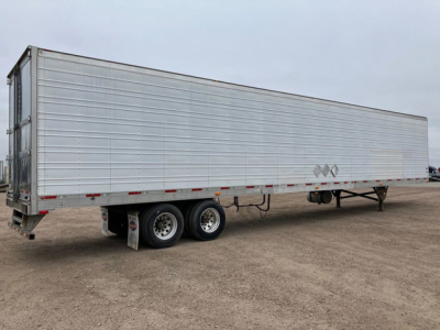 Trailer side view showing a silver refrigerated trailer with dual rear axles and smooth metal siding.