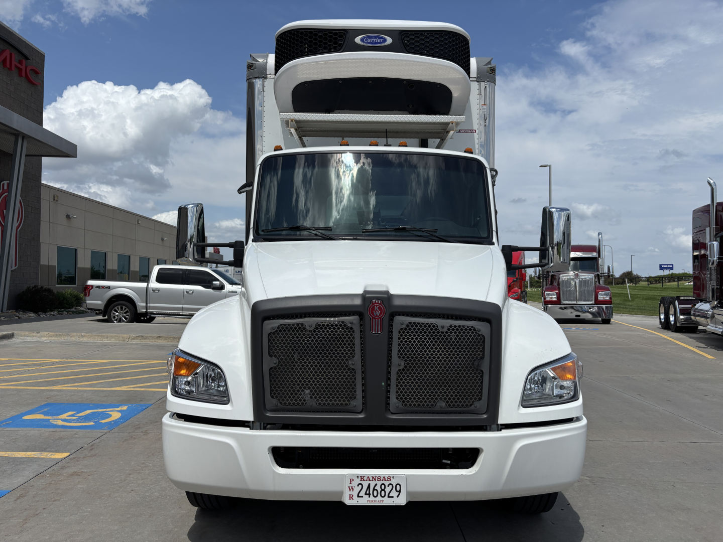 Kenworth T380 refrigerated truck front view showing grille, bumper, and VIN sticker area.