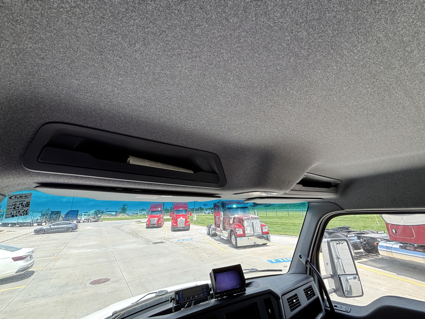 Kenworth T380 interior/front windshield view showing overhead interior panel and dashboard screen.