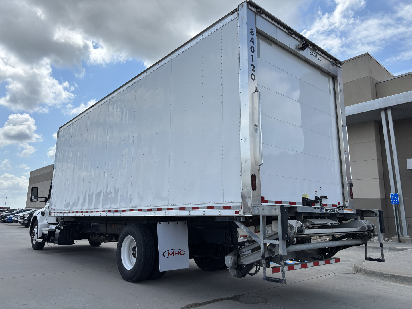 Kenworth T380 refrigerated truck rear/side view showing box trailer and bumper ramp.