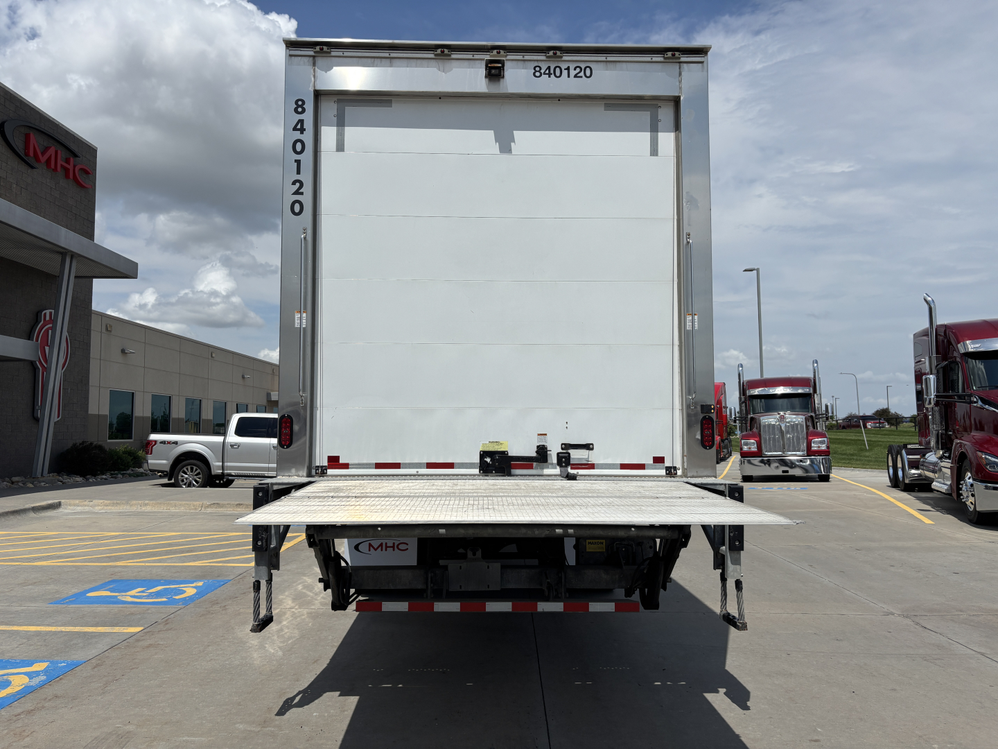 Kenworth T380 refrigerated truck rear view with liftgate deployed and stock number visible