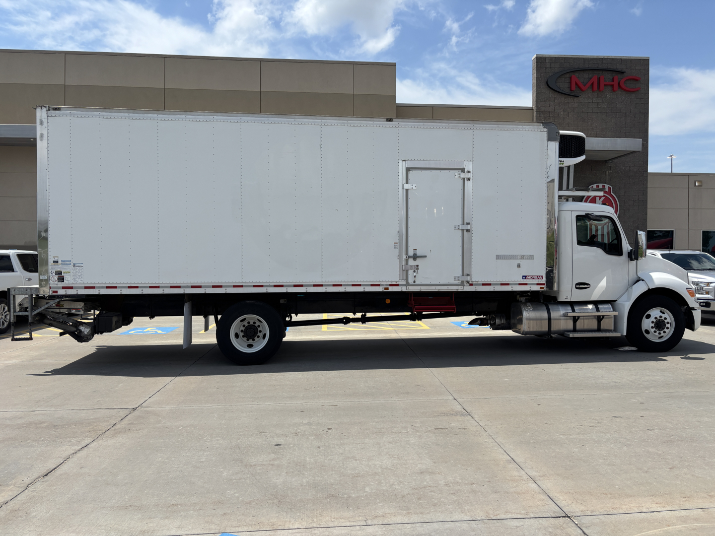 Kenworth T380 refrigerated box truck side view showing cargo box with rear doors and cab.
