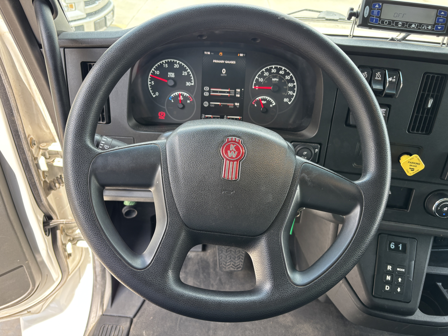 Kenworth T380 steering wheel and dashboard with gauges and controls visible inside cab