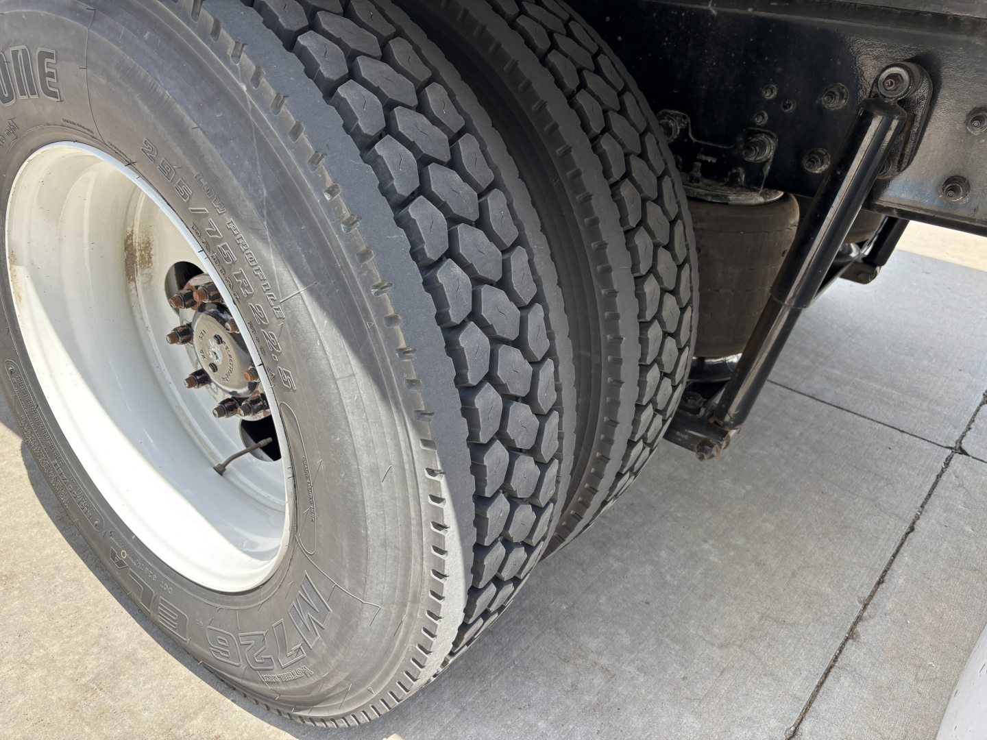 Kenworth T380 wheel and dual rear tires with suspension components visible; no legible labels or fluid reservoirs in view.