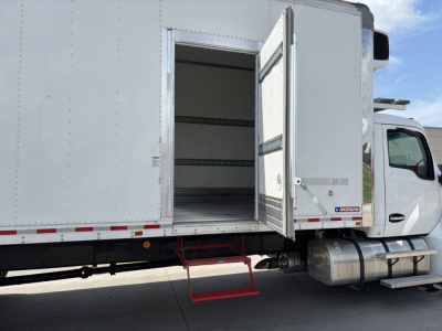 Kenworth T380 refrigerated truck side with open rear cargo area and red entry step visible