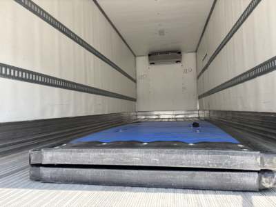 Interior of a Kenworth T380 refrigerated truck trailer showing empty cargo area with a blue tarp and insulated walls.