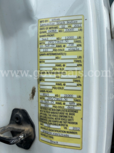 Vehicle identification plate on Ford F-750 showing weights, GVWR, GAWR, tire sizes, and manufacturing details.
