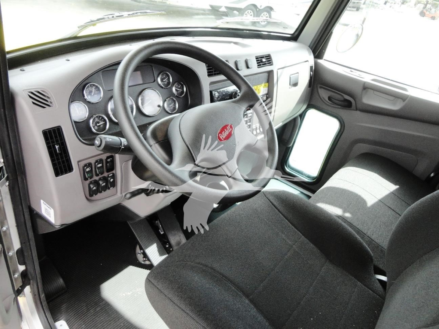 Peterbilt 337 truck cab interior showing steering wheel and dashboard with gauges and controls.