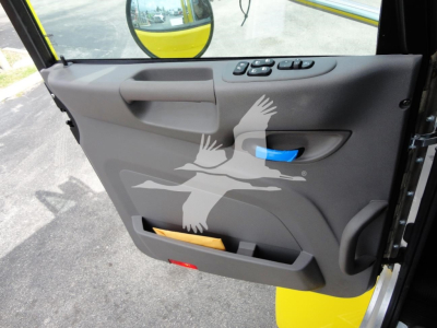 Peterbilt 337 truck door panel showing window controls and storage pocket with a faded bird logo.